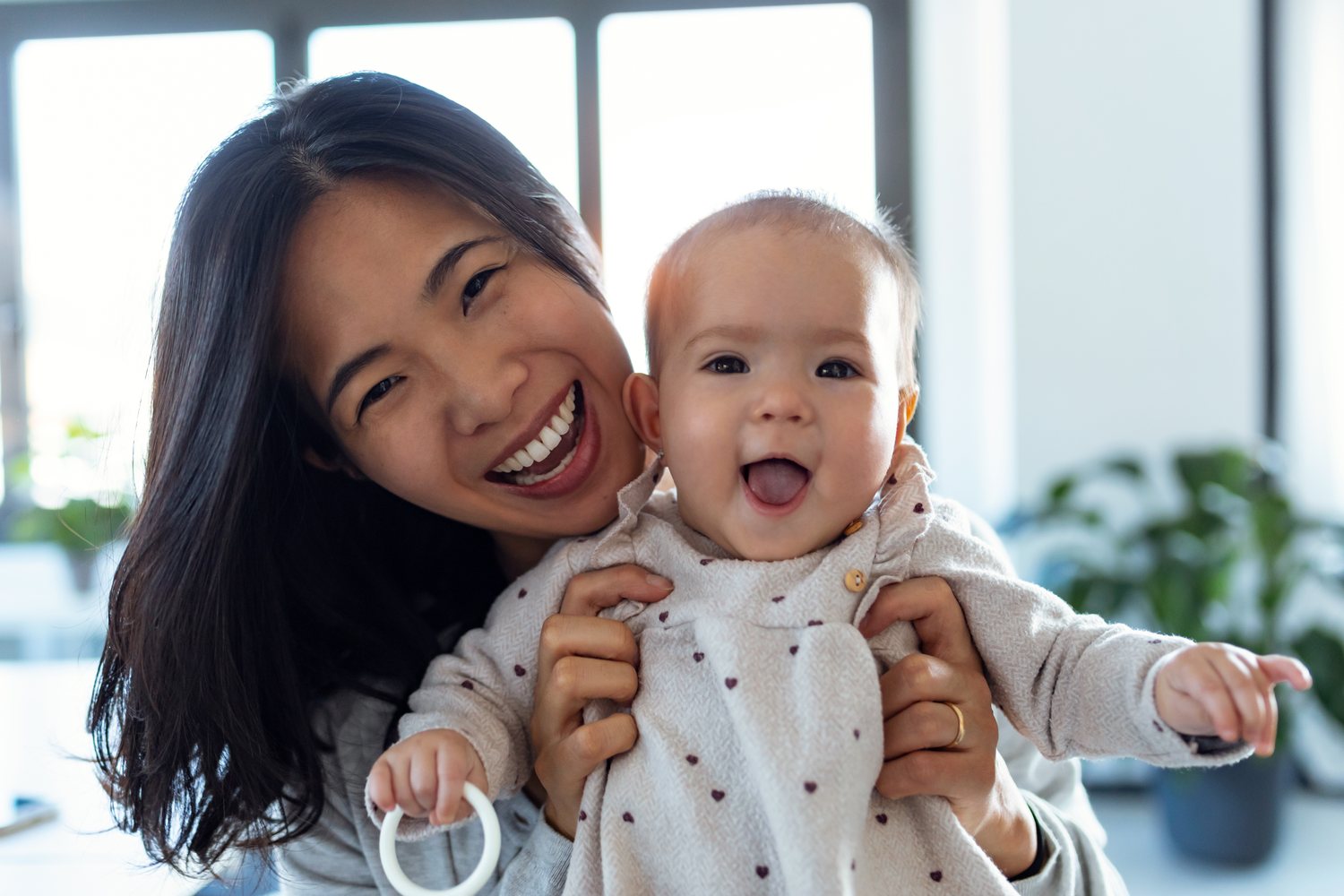 A mother holding her laughing baby